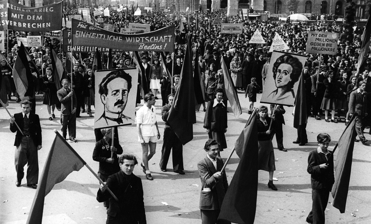 May 1948:  May Day marchers in East Germany carrying flags and pictures of Spartacist leaders Karl Liebknecht and Rosa Luxemburg.  (Photo by Fox Photos/Getty Images)