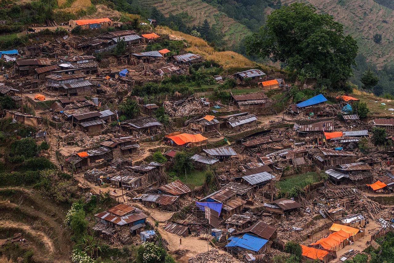 GORKHA, NEPAL - MAY 06:  Damaged houses are seen in a village from an Indian Helicopter on May 6, 2015 near Gorkha, Nepal.  A major 7.9 earthquake hit Kathmandu mid-day on Saturday 25th April, and was followed by multiple aftershocks that triggered avalanches on Mt. Everest that buried mountain climbers in their base camps. Many houses, buildings and temples in the capital were destroyed during the earthquake, leaving over 7000 dead and many more trapped under the debris as emergency rescue workers attempt to clear debris and find survivors. Regular aftershocks have hampered recovery missions as locals, officials and aid workers attempt to recover bodies from the rubble.  (Photo by David Ramos/Getty Images)