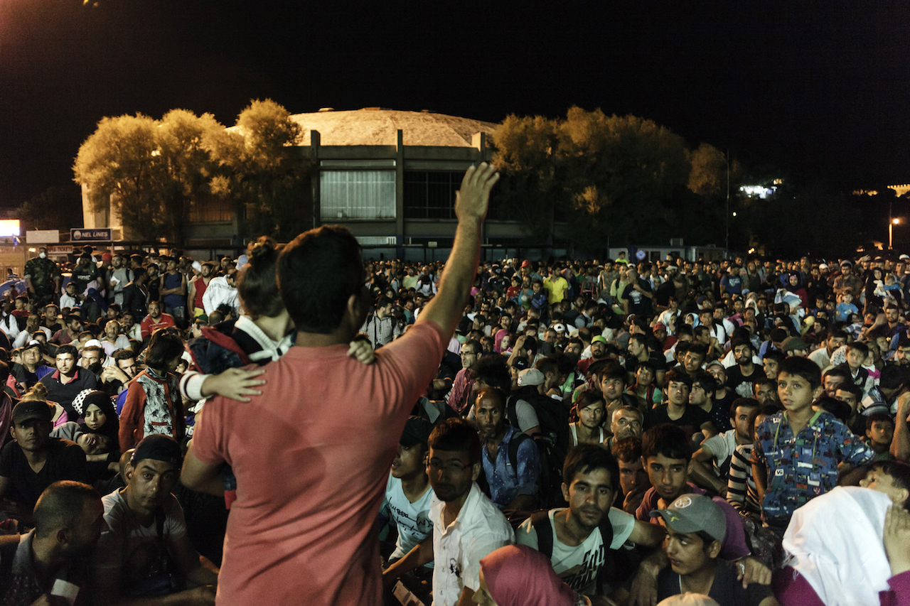 Syrian migrants wait to board on the Eleftherios Venizelos ferry to be transported to mainland Greece on August 23, 2015 at the port of Mytilene, on Lesbos Island. AFP PHOTO / ACHILLEAS ZAVALLIS