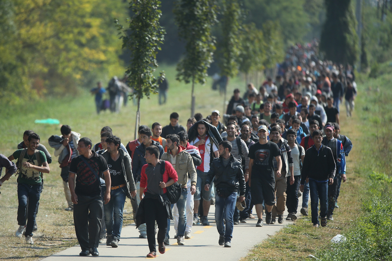HEGYESHALOM, HUNGARY - SEPTEMBER 23:  Hundreds of migrants who arrived by train at Hegyeshalom on the Hungarian and Austrian border walk the four kilometres into Austria on September 23, 2015 in Hegyeshalom, Hungary. Thousands of migrants have arrived in Austria with more en-route from Hungary, Croatia and Slovenia.  EU leaders are attending an extraordinary summit on today to try and solve the crisis. (Photo by Christopher Furlong/Getty Images)