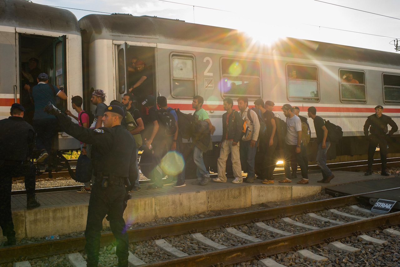 TOVARNIK, CROATIA - SEPTEMBER 23:  Migrants board a train heading for Zagred at Tovarnik station, as more migrants arrive from the Serbian border, on September 23, 2015 in Tovarnik, Croatia. Croatia has built a refugee camp to control the transit of migrants to Hungary with a capacity of 4,000 people. EU leaders attended an extraordinary summit today in Brussels in an attempt to resolve the ongoing crisis. (Photo by David Ramos/Getty Images)