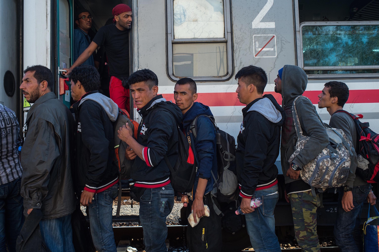TOVARNIK, CROATIA - SEPTEMBER 23:  Migrants board a train heading for Zagred at Tovarnik station, as more migrants arrive from the Serbian border, on September 23, 2015 in Tovarnik, Croatia. Croatia has built a refugee camp to control the transit of migrants to Hungary with a capacity of 4,000 people. EU leaders attended an extraordinary summit today in Brussels in an attempt to resolve the ongoing crisis. (Photo by David Ramos/Getty Images)