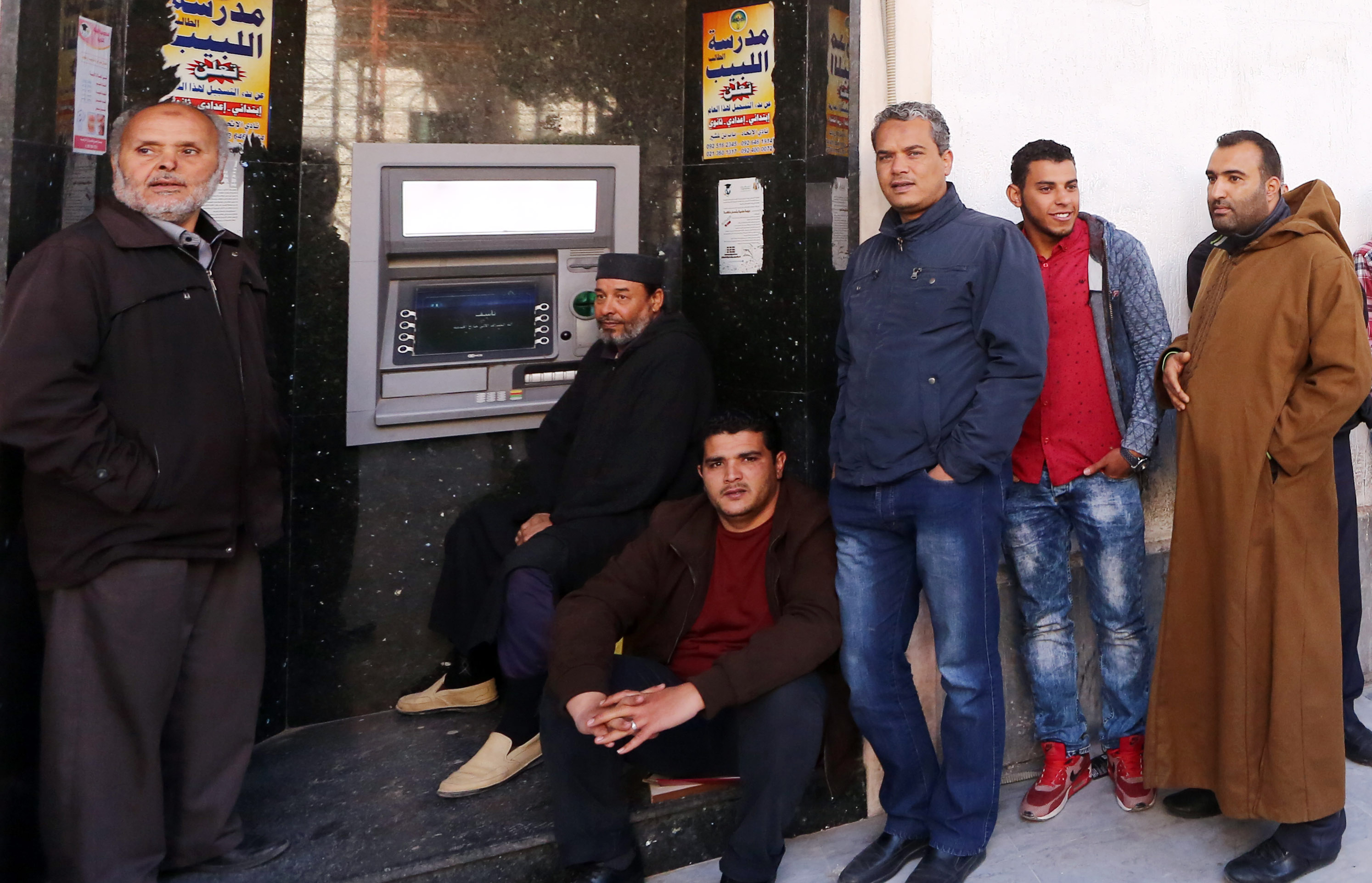 Készpénzre váró emberek Tripoliban (AFP PHOTO / MAHMUD TURKIA)