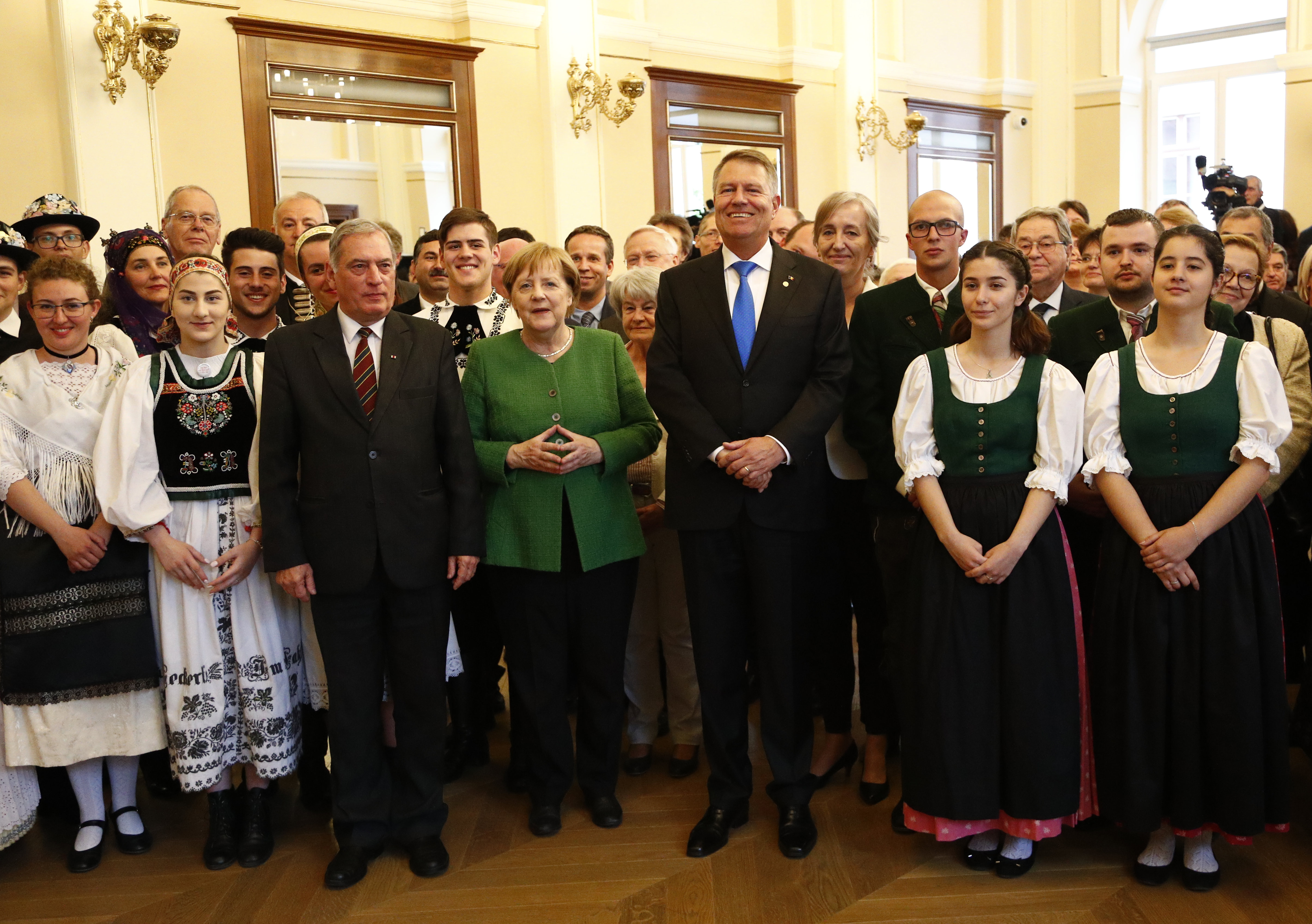 Angela Merkel és Klaus Iohannis nagyszebeni szász hagyományőrzők gyűrűjében 2019 májusában Nagyszebenben